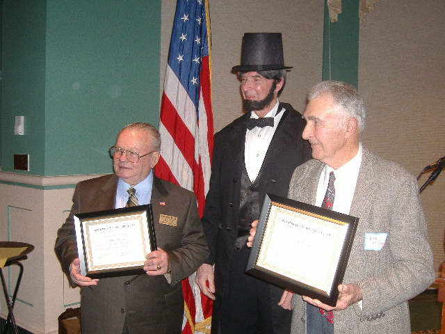 President Lincoln stayed long enough to honor two 'Republican of the Year' men. With their plaques, on the left is Blan Harcum and on the right is Bob Miller.
